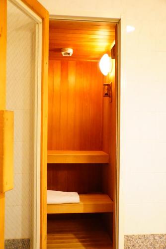 a closet with wooden shelves in a room at Hotel Sunset Terrace in Chatan