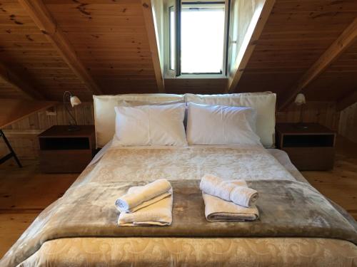 a bedroom with a bed with two towels on it at Villa Aliki in Petrokhorion