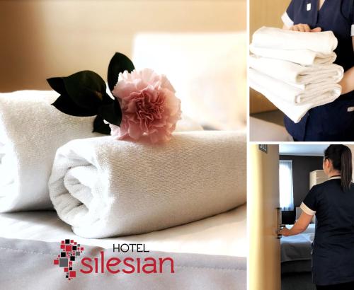 
a doll sitting on top of a bed next to pillows at Economy Silesian Hotel in Katowice
