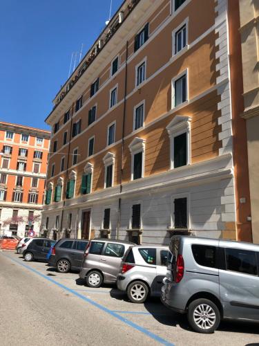 Cavour Suites Guest House في روما: صف من السيارات تقف امام مبنى