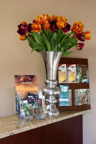a vase of flowers sitting on a shelf at Tambati Overnight and Conference Center in Polokwane