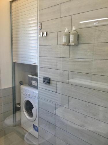 a bathroom with a washer and a washing machine at Elite19 Apartment in Bocca di Magra