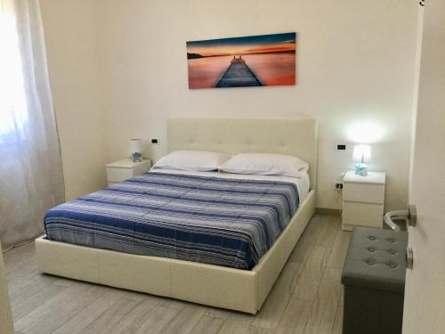 a bedroom with a bed and a painting on the wall at Elite19 Apartment in Bocca di Magra
