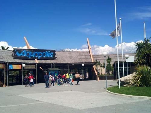 a group of people walking in front of a store at Maldivas Planet Costa Dorada in La Pineda