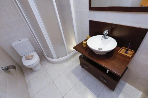 a bathroom with a sink and a toilet at Maldivas Planet Costa Dorada in La Pineda