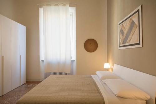a bedroom with a bed and a window at Regis Condo in Siena