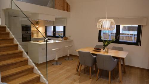 a kitchen and dining room with a table and chairs at Casiñas Mariñeiras (Taberna Vella) in Portosin