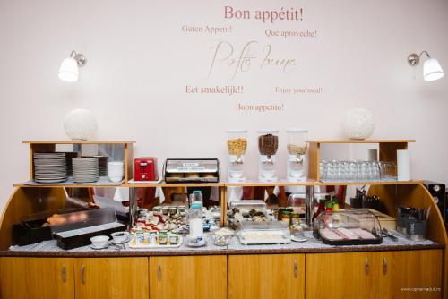 a kitchen with a counter full of food at Hotel Iris in Tîrnăveni