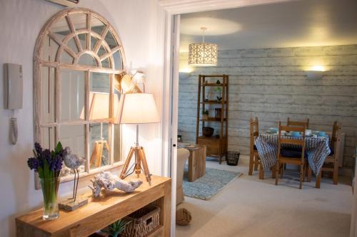 a living room with a table and a dining room at The Beach House Holiday Apartments in Eastbourne