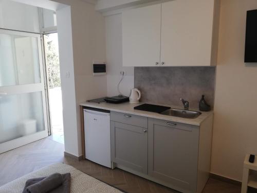 a kitchen with a sink and a counter top at PortoBello in Portorož