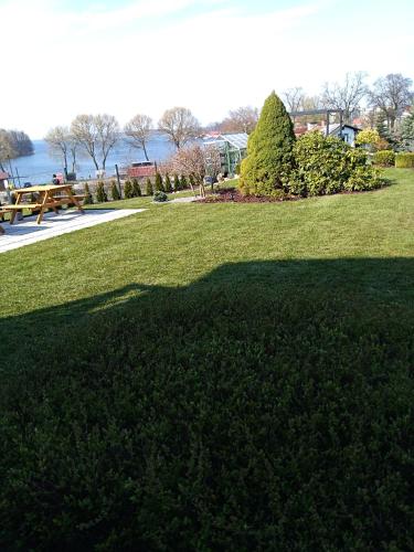 a large shadow on the grass in a park at Pokoje gościnne Venezia in Czaplinek
