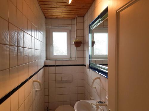 a bathroom with a sink and a toilet and a window at Ferienwohnung Moni in Bräunlingen