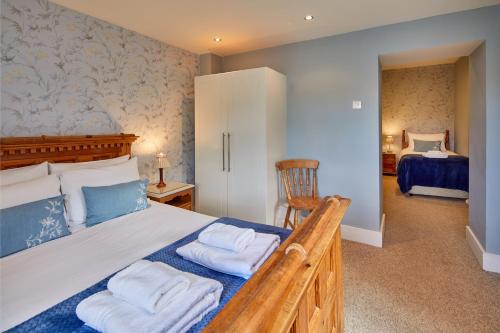 a bedroom with a large bed with two pillows at White Horse Farm Inn in Pickering