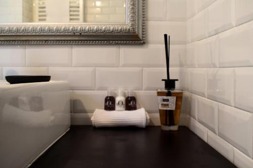 a bathroom with a pair of shoes and a mirror at PLAN SEA Guest House in Santa Margherita Ligure