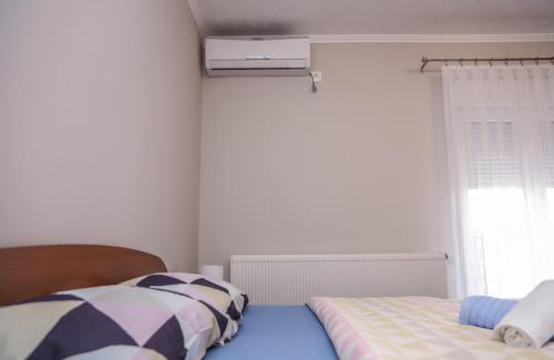 a bedroom with two beds and a window at Hotel ZRINSKI in Koprivnica