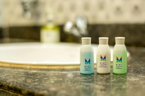 three bottles of milk sitting on top of a counter at Eclat Suites MINT Gomti Nagar in Lucknow