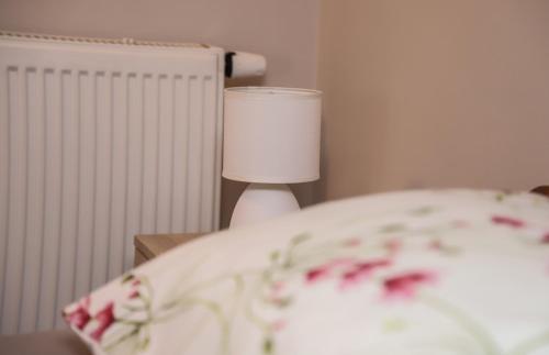 a close up of a bed with a lamp at Hotel ZRINSKI in Koprivnica