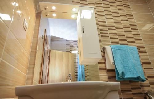 a bathroom with a sink and a mirror and a tub at Hotel ZRINSKI in Koprivnica