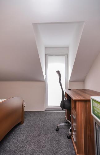 an office with a desk and a chair in a room at Hotel ZRINSKI in Koprivnica