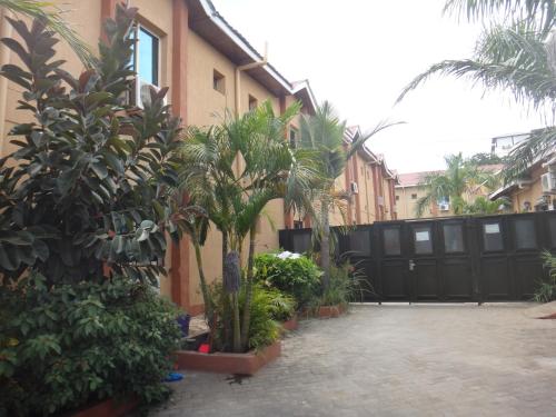 a courtyard with trees and plants in front of a building at Quality Hotel Juba in Juba