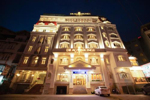 a large white building with a sign on it at Dragon King 1 Hotel in Da Lat