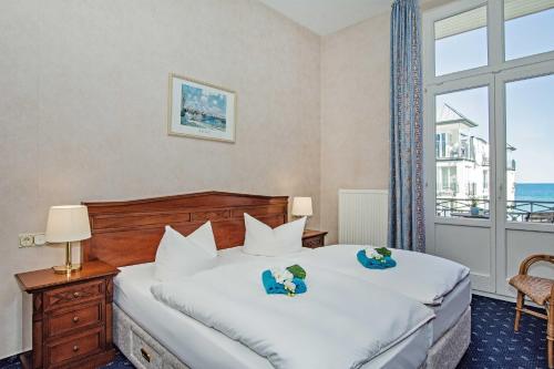 a bedroom with a bed and a large window at Villa Sommerfreude in Bansin