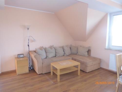 a living room with a couch and a table at Kantal Apartamenty Hel in Hel