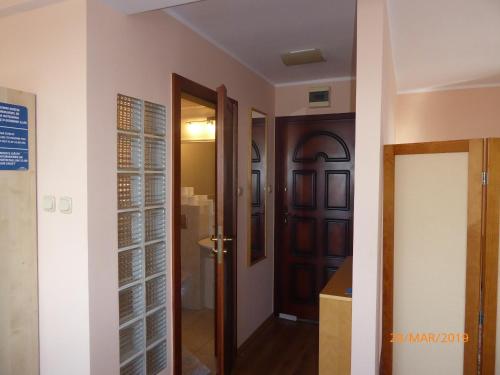 a hallway with a door and a room at Kantal Apartamenty Hel in Hel