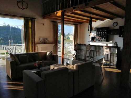 a living room with two couches and a bar at Melford Nuwaraeliya in Nuwara Eliya
