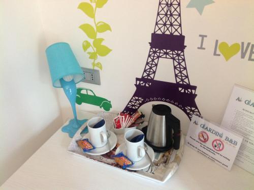a toy figurine of the eiffel tower and tea set at Ai Giardini Rooms -vicino Ospedale Borgo Trento e centro storico in Verona