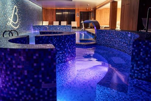 a hotel lobby with blue tiles on the floor at Relais Bernard Loiseau in Saulieu