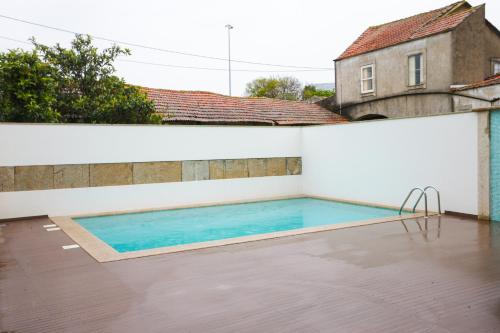 a swimming pool on the roof of a house at RURAL HOUSE in Guifões