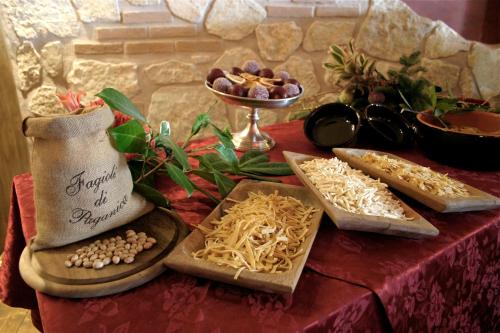 a table topped with different types of food on a table at Hotel Fiordigigli in Assergi