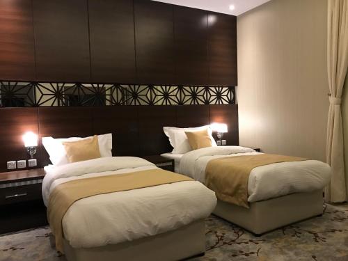 a hotel room with two beds in a room at Ayan Hotel in Riyadh