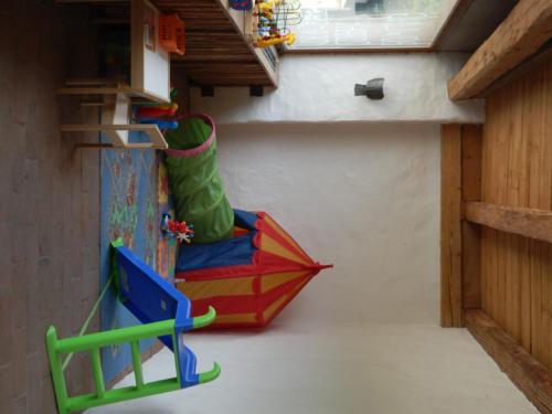 a play room with a slide and an umbrella at Hotel Stara Skola in Sloup