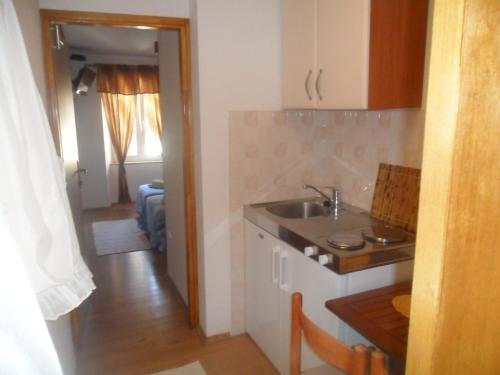 a kitchen with a sink and a counter top at Guest House Leon in Korčula