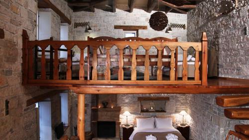 a wooden staircase in a room with a bedroom at Artsistas Houses in Aristi