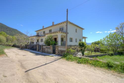 a house on the side of a dirt road at aMatalasviñas in Piedralaves
