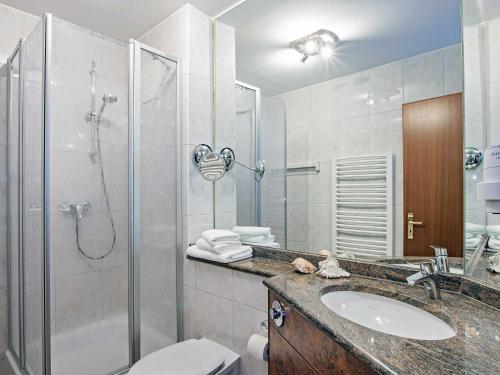 a bathroom with a shower and a sink and a toilet at Villa Sommerfreude in Bansin