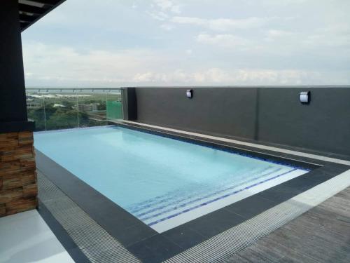 a swimming pool on the roof of a building at Cityscape Residences, Unit 702 in Bacolod