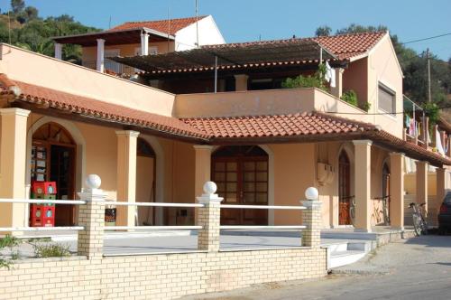 a house with a fence in front of it at Patras Roof apartment in Agios Georgios Pagon