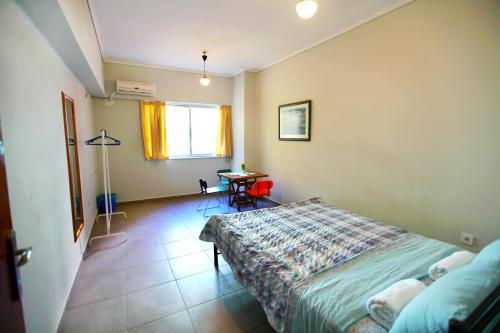 a bedroom with a bed and a table in it at SleepEasy in Athens