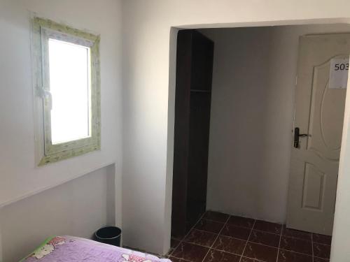 a bedroom with a door and a window and a bed at Colour Holidays in Cairo