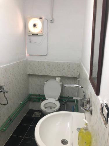 a small bathroom with a toilet and a sink at Colour Holidays in Cairo