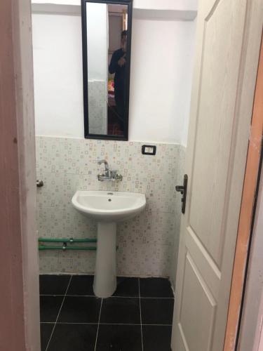 a bathroom with a sink and a mirror at Colour Holidays in Cairo
