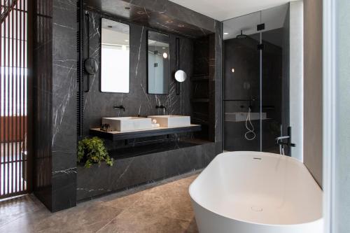 a bathroom with a white toilet and a sink at Perianth Hotel, a Member of Design Hotels in Athens