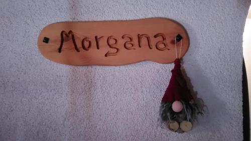 a surfboard hanging on a wall with the wordzona at MolinDeiMaghi in Fondo