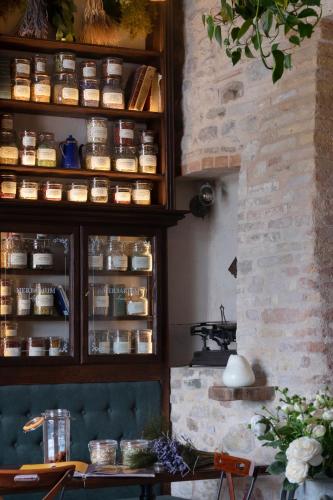 a kitchen with a counter with jars of food at Borgo Antichi Orti Assisi in Assisi