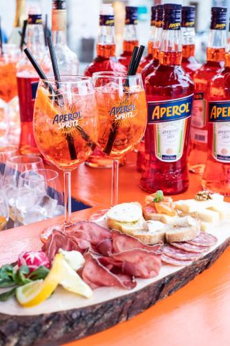 a plate of food and two glasses of wine at Hotel Compagnoni in Livigno