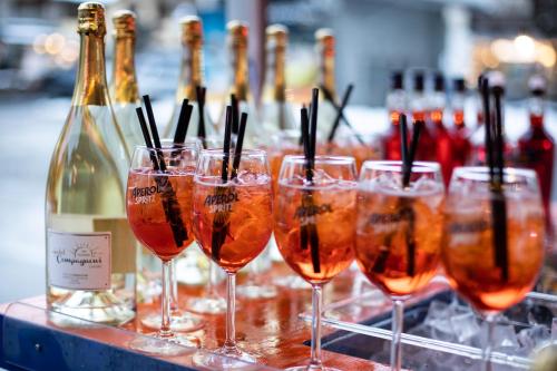 a row of wine glasses with bottles of wine at Hotel Compagnoni in Livigno